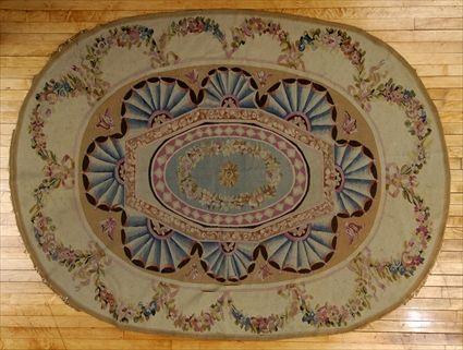 Appraisal: AUBUSSON-STYLE OVAL CARPET The central wreath on pale blue oval