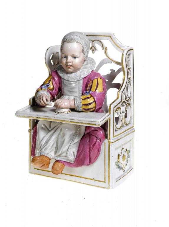 Appraisal: A CONTINENTAL FAIENCE FIGURE OF A CHILD seated in an