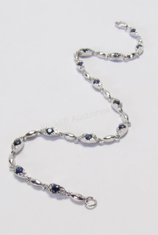 Appraisal: A K white gold bracelet with thirteen brilliant cut sapphires