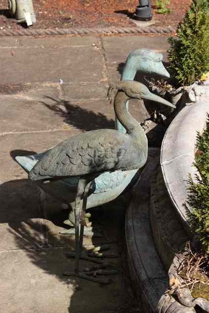 Appraisal: A BRONZE SCULPTURE of a heron high together with a