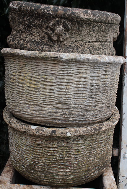 Appraisal: A PAIR OF CYLINDRICAL COMPOSITE MOULDED BASKET WEAVE DECORATED PLANTERS