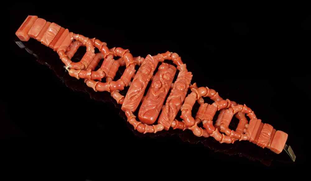 Appraisal: CARVED CORAL BRACELET Floriform and round beads woven in rings