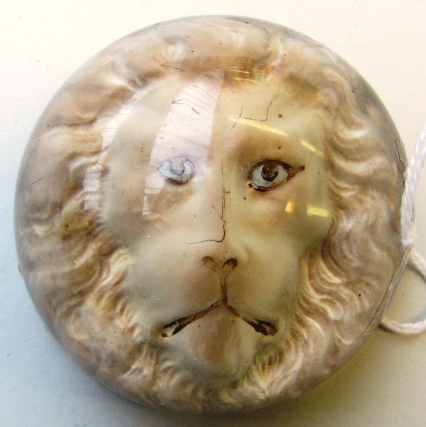 Appraisal: An unusual Continental glass desk weight with lion's head inclusion