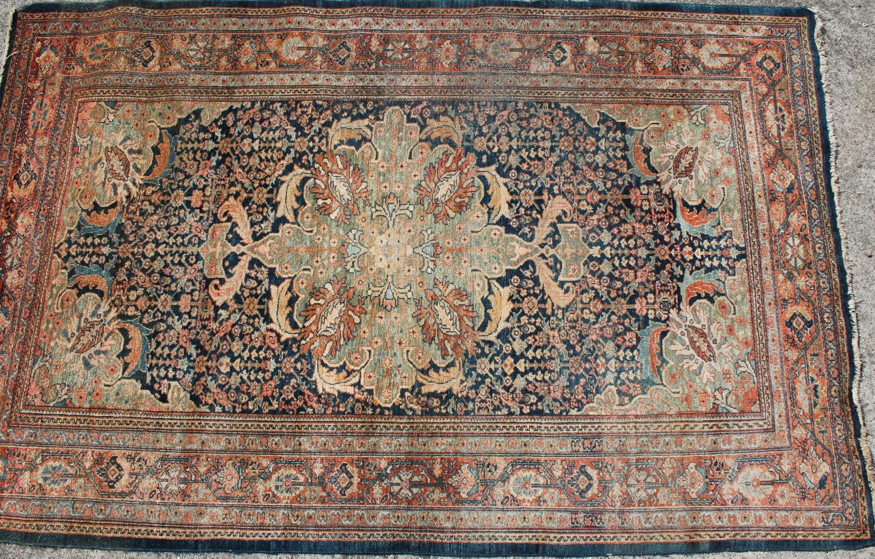 Appraisal: A Middle Eastern rug in a geometric floral pattern predominantly