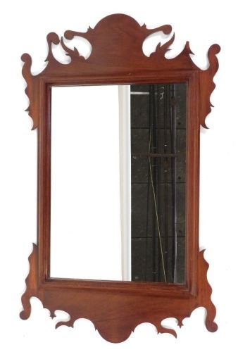 Appraisal: A fret framed mahogany wall mirror with arched swan top