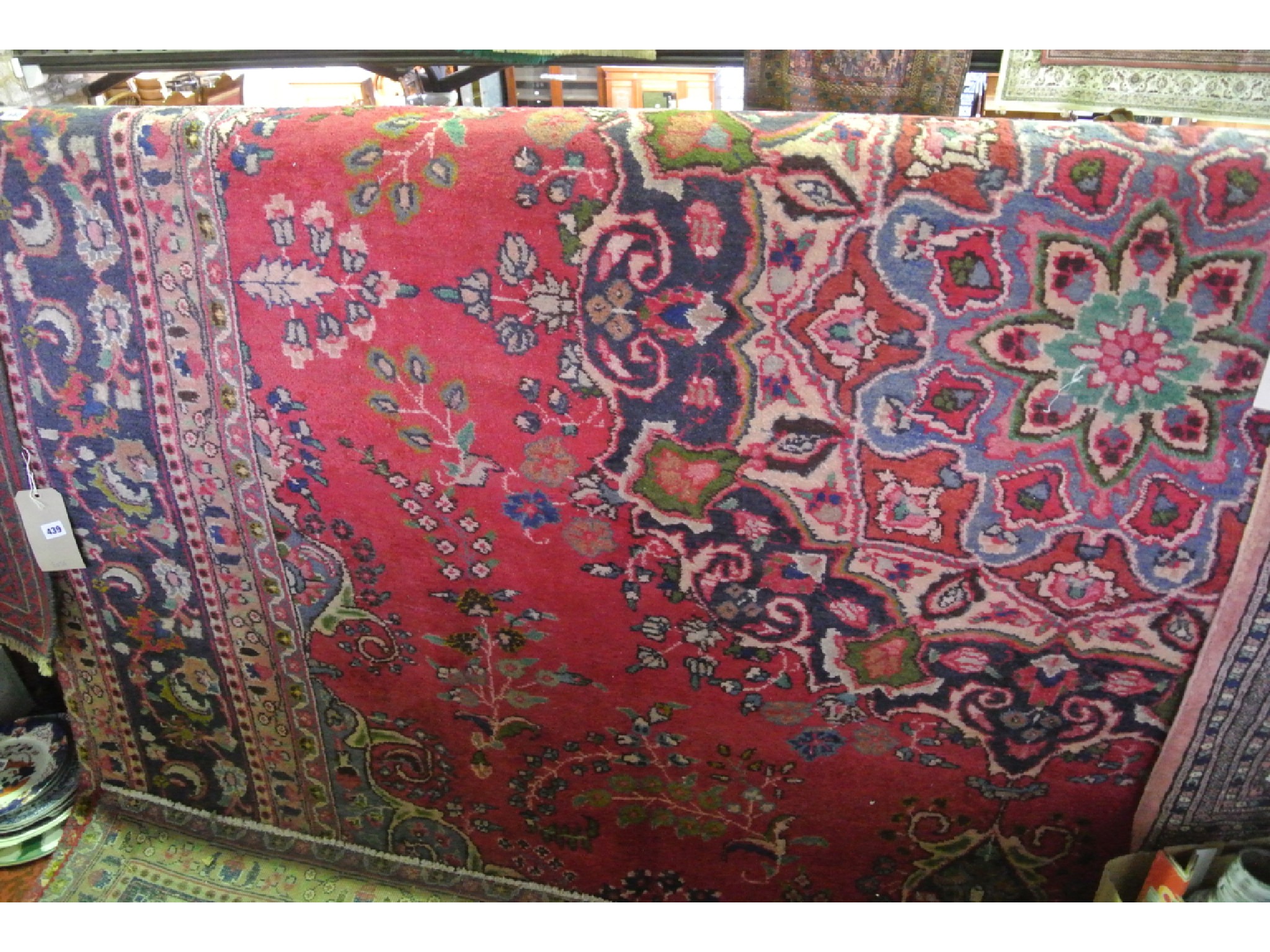 Appraisal: A substantial good quality woven wool carpet the red ground