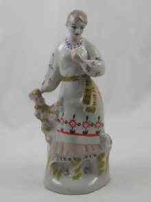 Appraisal: A Russian Duleve porcelain figure of peasant girl marked to