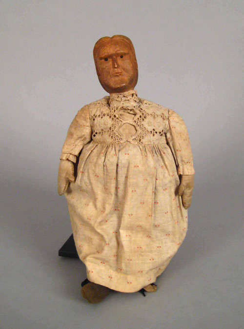 Appraisal: Carved pine doll th c with period dress and glass