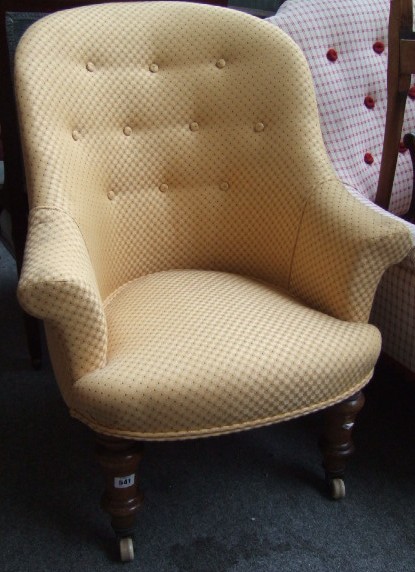 Appraisal: A Victorian tub chair on turned mahogany legs and castors