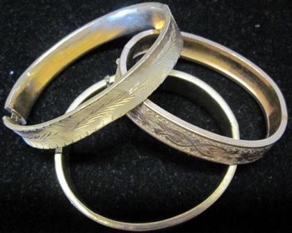 Appraisal: Three yellow gold and gold filled bangle bracelets dwt