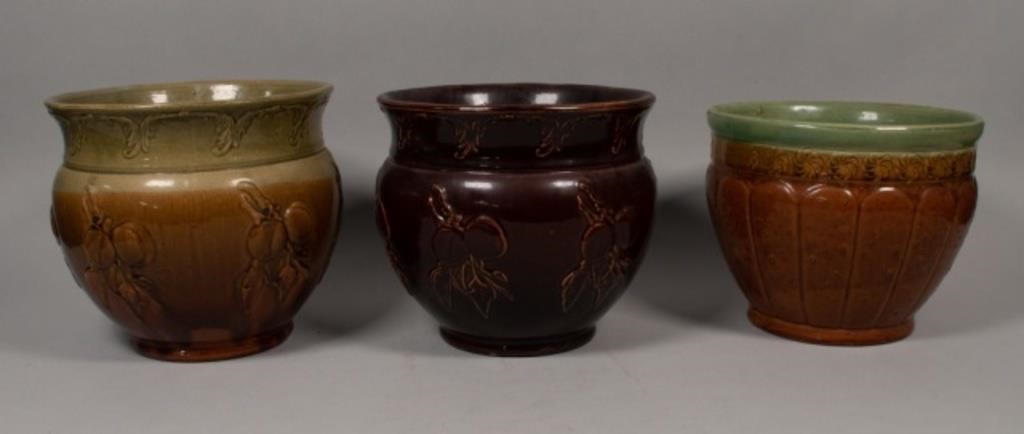 Appraisal: English brown stoneware planters with harvest motifs Largest H x