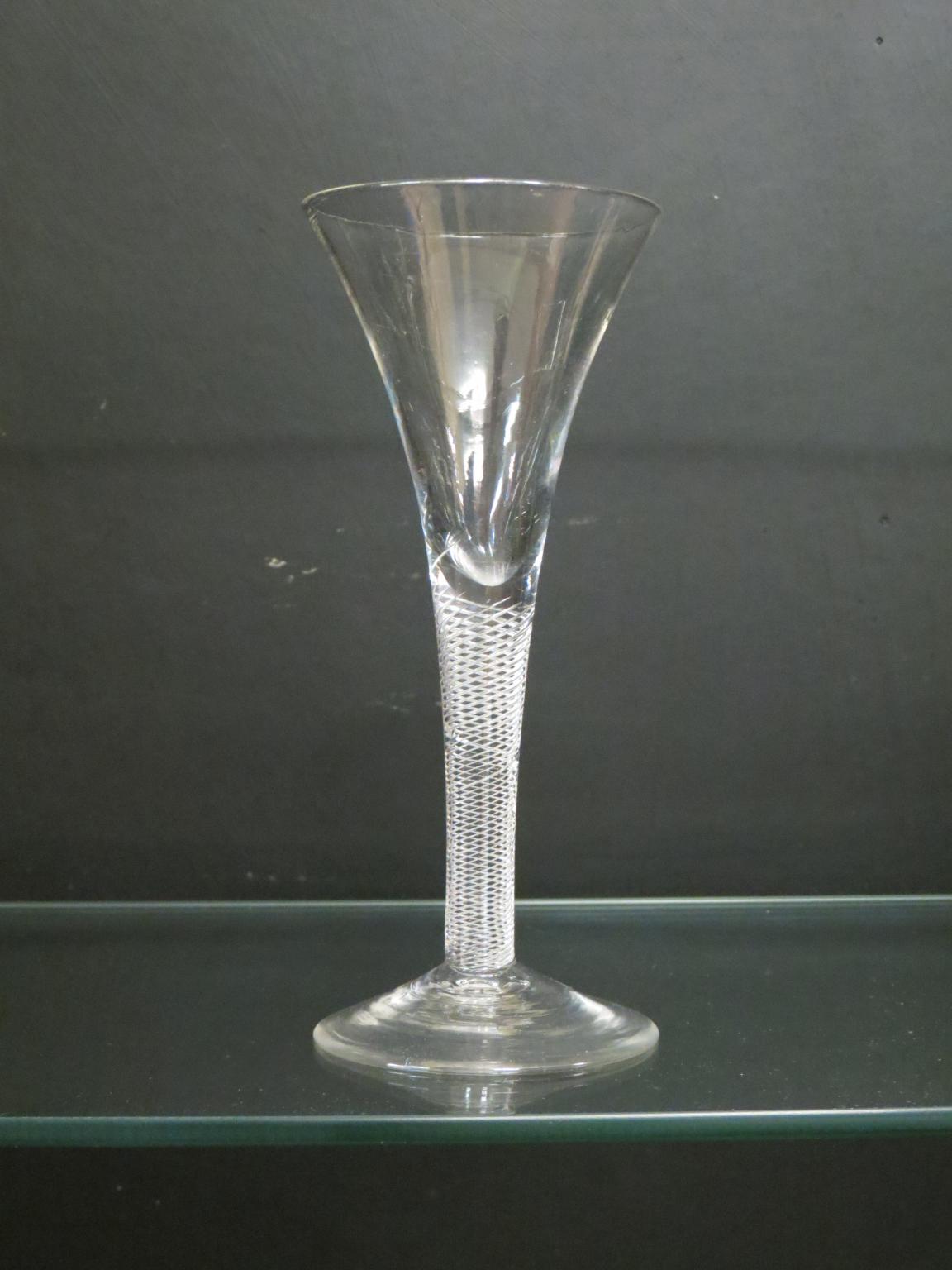 Appraisal: An th century English wine glass drawn-trumpet form with air-twist