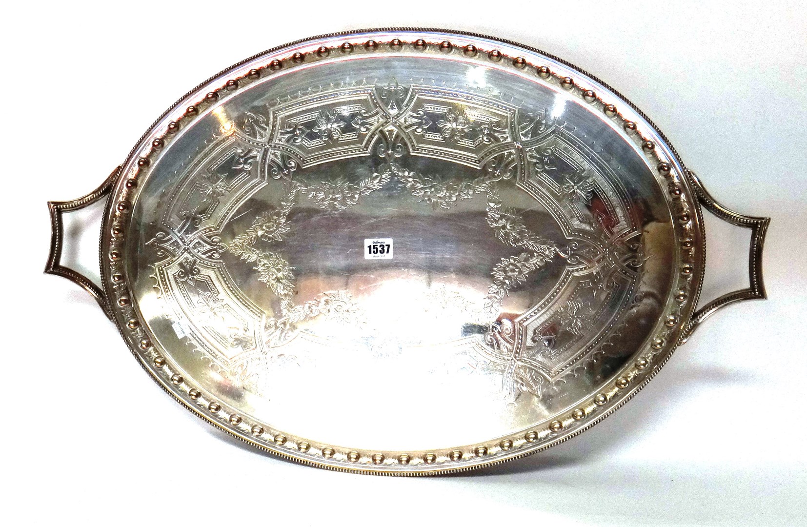 Appraisal: A plated oval twin handled tray with engraved decoration to