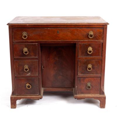 Appraisal: A George III mahogany kneehole desk fitted drawers around a