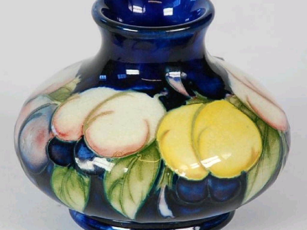 Appraisal: MOORCROFT POTTERY SMALL SQUAT BULBOUS VASE painted with fruit on