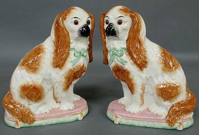 Appraisal: Pair of Staffordshire red and white seated Spaniels with glass