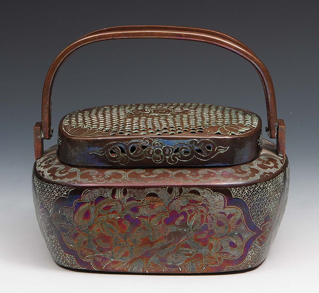 Appraisal: A Chinese copper hand-warmer th Centuryof oval form with split