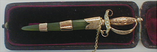 Appraisal: A sword shaped brooch with seed pearl set handle with