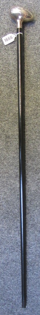 Appraisal: An ebonised walking cane with egg shaped silver handle hallmarks