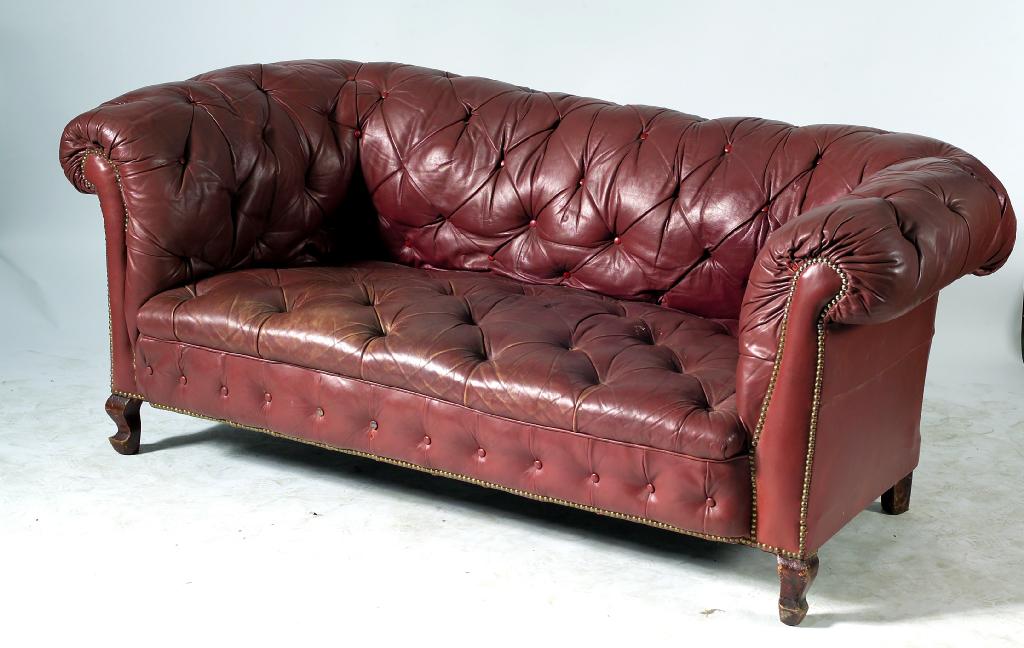 Appraisal: VICTORIAN DEEP-BUTTONED LEATHER CHESTERFIELD SOFA of characteristic boldly scrolling form