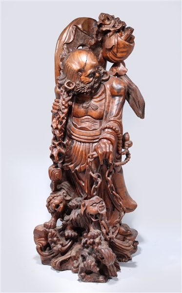 Appraisal: Large Chinese carved hardwood statue of a deity with dogs