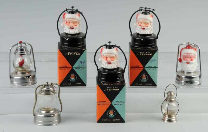 Appraisal: Lot of Santa Lanterns Description Three Santa head lanterns are