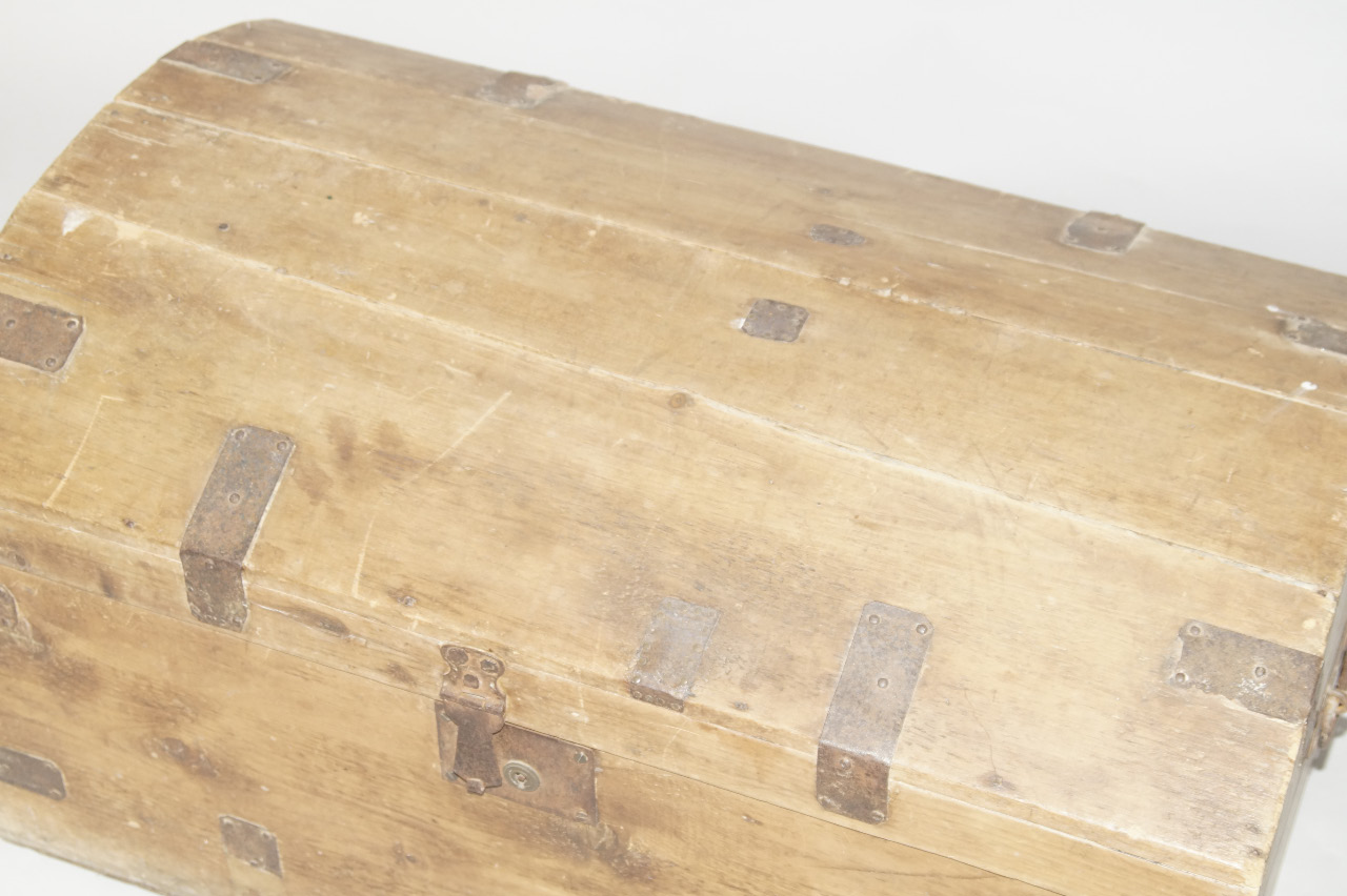 Appraisal: A pine dome top chest with hinged lid and iron