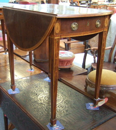 Appraisal: A George III mahogany Pembroke table the oval cross banded