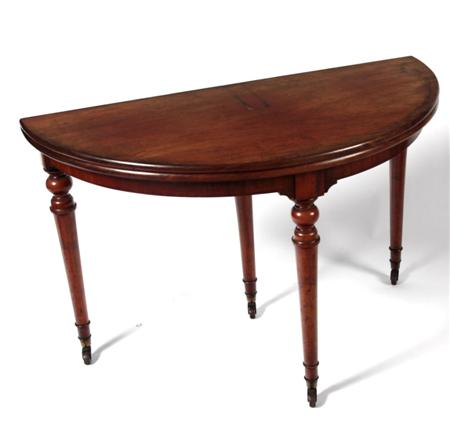 Appraisal: A Victorian mahogany demi-lune fold over table with beaded frieze