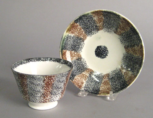 Appraisal: Brown and black rainbow spatter cup and saucer th c