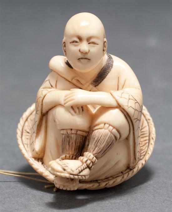 Appraisal: Japanese carved ivory netsuke Man seated on a hat first