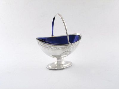 Appraisal: A George III silver swing-handled basket of oval form engraved