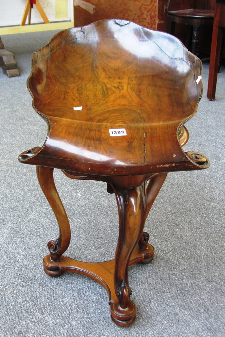 Appraisal: A Portuguese walnut revolving piano stool scallop shaped seat on