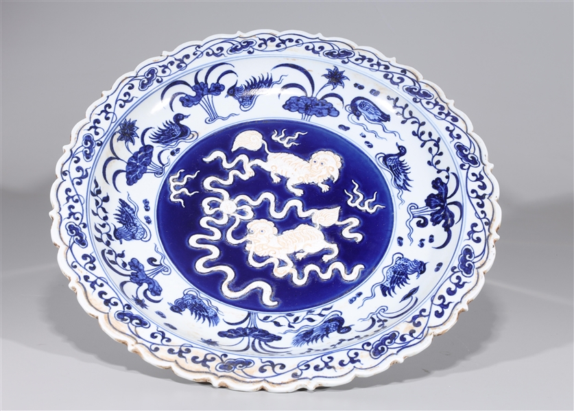 Appraisal: Chinese blue and white porcelain charger with dragons in relief