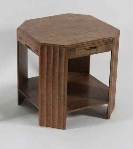 Appraisal: An Art Deco oak octagonal table with four slides on