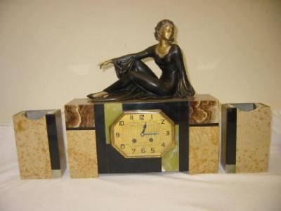 Appraisal: A FRENCH ART DECO CLOCK GARNITURE the drum movement striking