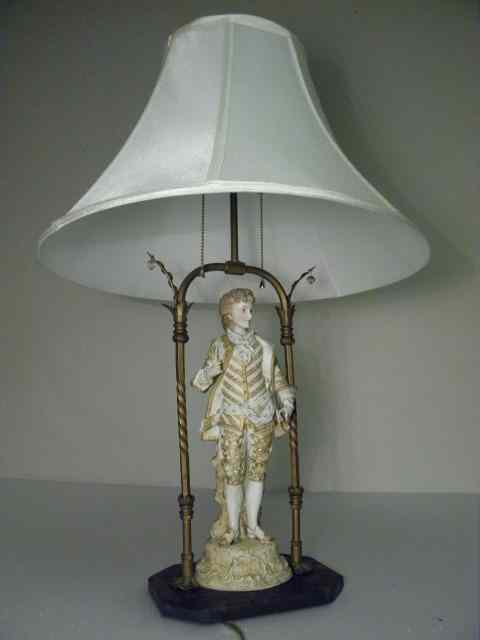 Appraisal: Bisque porcelain figural table lamp with black marble base and