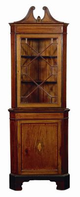 Appraisal: An Edwardian mahogany standing corner cupboard with satinwood crossbanding stringing