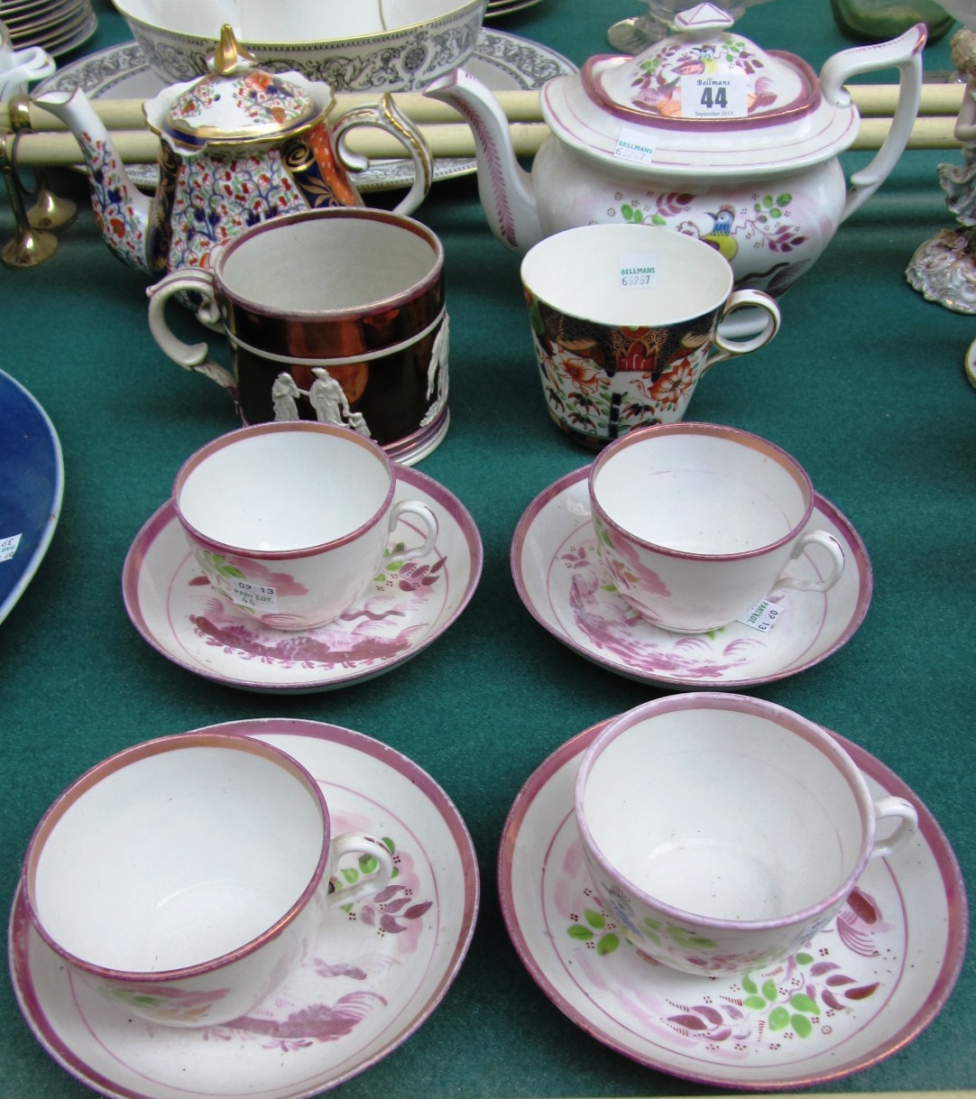 Appraisal: A purple lustre decorated teapot and four cups and saucers