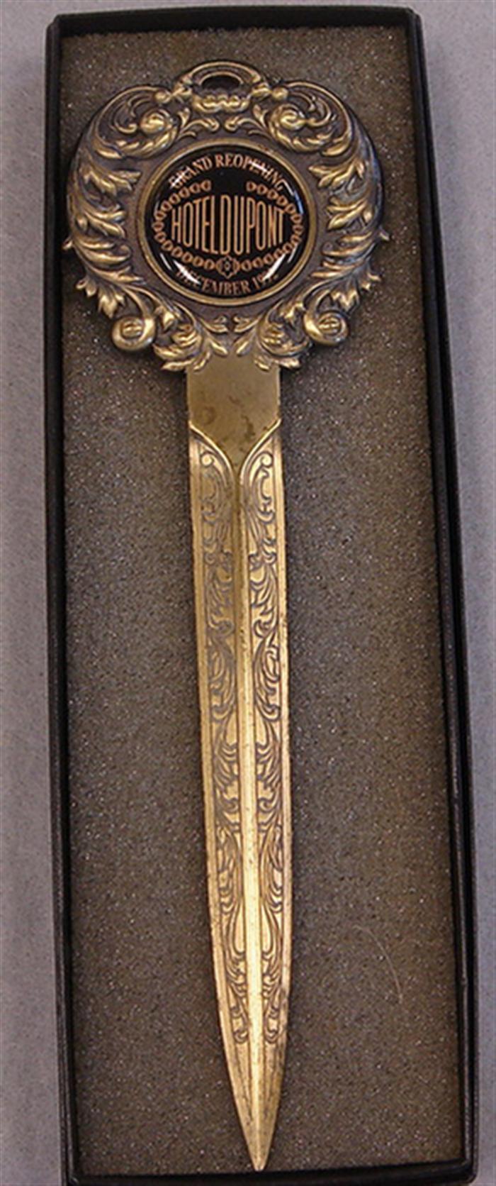 Appraisal: Vintage brass letter opener Medallion reads Grand Reopening Hotel DuPont