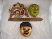 Appraisal: Three Indonesian theatre masks c together with a decorated hardwood