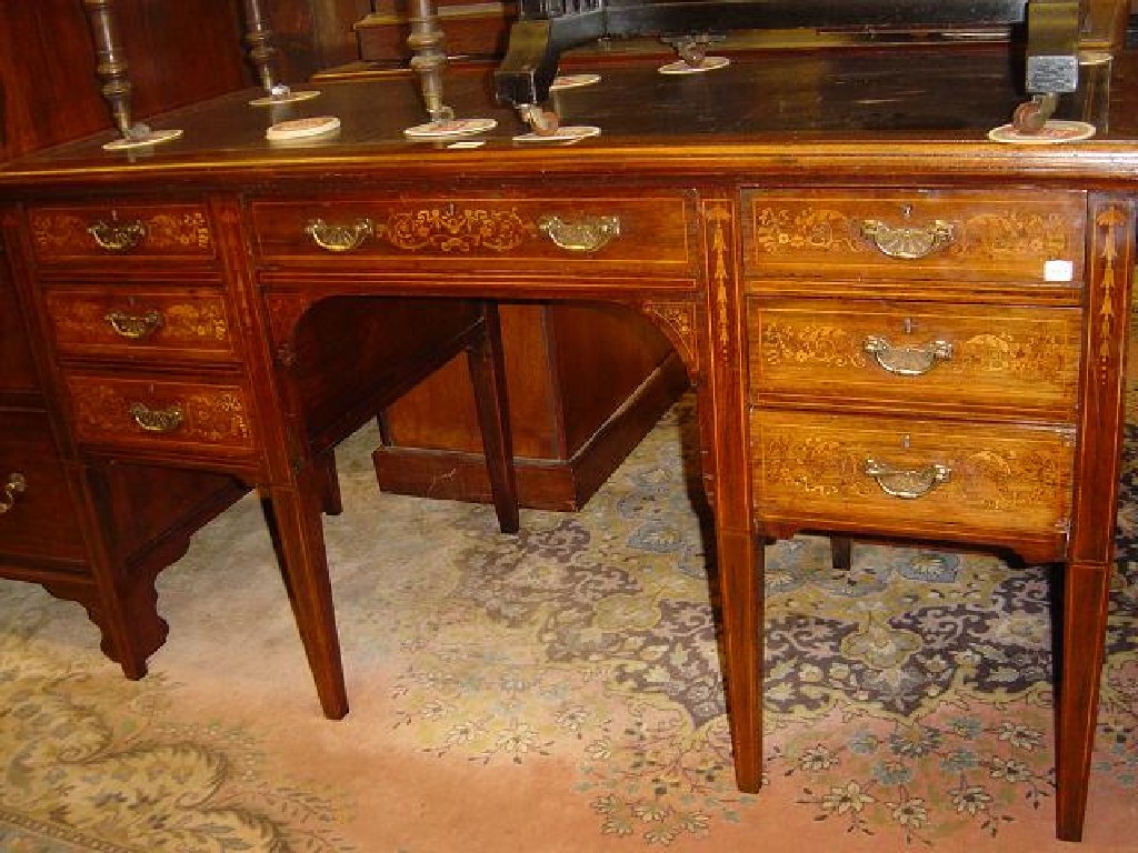 Appraisal: An inlaid Edwardian rosewood kneehole writing table with inset leather