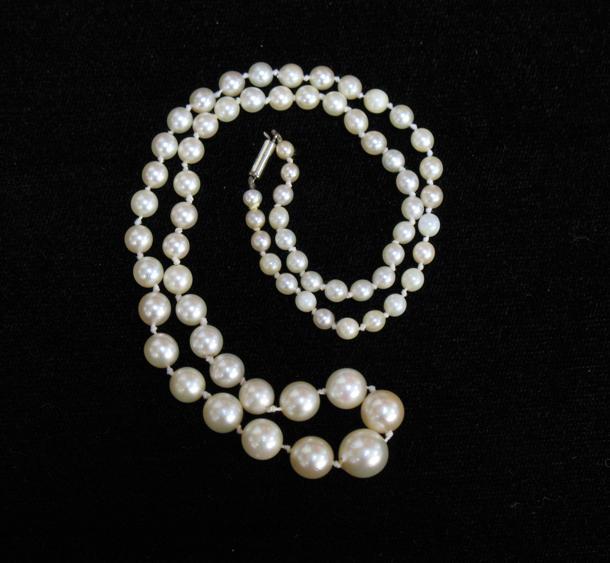 Appraisal: A GRADUATED STRING OF CULTURED PEARLS with a plain ct