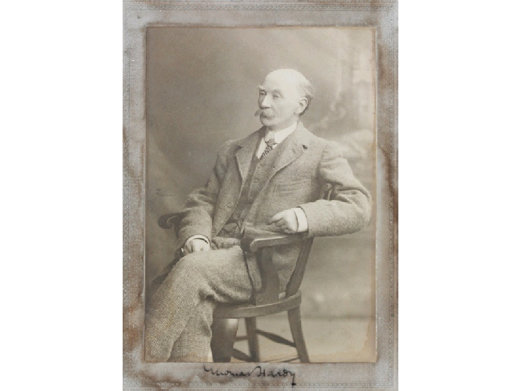 Appraisal: THOMAS HARDY A studio photograph of Hardy seated aged about