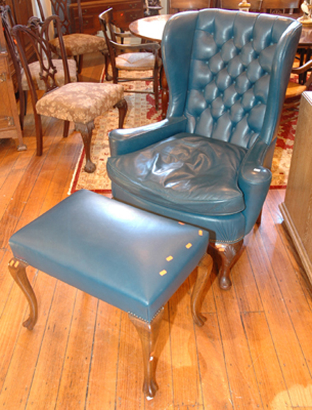 Appraisal: A GEORGE II STYLE WINGBACK ARMCHAIR AND STOOL The shaped