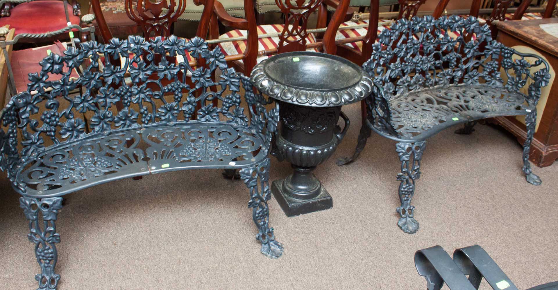 Appraisal: Two cast iron patio benches and an urn