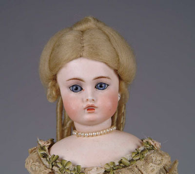 Appraisal: BELTON FACED CLOSED MOUTH DOLL This swivel neck doll is