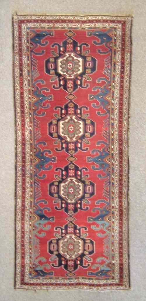 Appraisal: An antique Caucasian long rug woven in colours with central