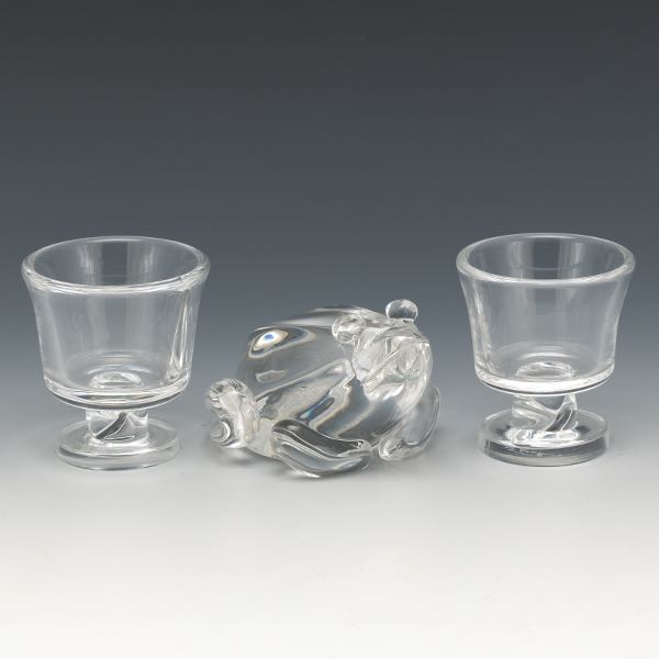 Appraisal: STEUBEN CLEAR GLASS FROG MASCOT AND PAIR OF CANDLEHOLDERS Including