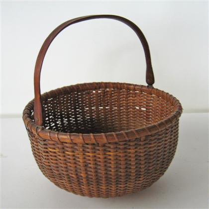 Appraisal: Nantucket basket with swing handle early th century Slightly oval